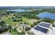 Aerial view of a property featuring mature trees, a dwelling, and multiple greenhouses at 17927 E Apshawa Rd, Minneola, FL 34715
