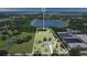 Aerial view of the property featuring a spacious lot with trees and waterfront views at 17927 E Apshawa Rd, Minneola, FL 34715