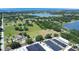 Aerial image of residential area with houses and lakes and agricultural buildings at 17927 E Apshawa Rd, Minneola, FL 34715
