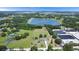 Panoramic aerial view showcases the property's location with lake access and sprawling greenery at 17927 E Apshawa Rd, Minneola, FL 34715