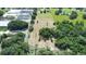 Aerial view showcasing wooded land, greenhouses, and land offering various possibilities at 17927 E Apshawa Rd, Minneola, FL 34715