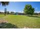 Spacious backyard with a shed, lush grass, and mature trees at 17927 E Apshawa Rd, Minneola, FL 34715