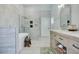 Bathroom featuring a soaking tub, walk-in shower, and modern vanity with sink at 17927 E Apshawa Rd, Minneola, FL 34715