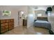 Bedroom with private bath, wood-look floors, and large windows for natural light at 17927 E Apshawa Rd, Minneola, FL 34715