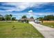 Charming single-story home boasts a well-manicured lawn, long driveway, and a bright, inviting exterior at 17927 E Apshawa Rd, Minneola, FL 34715