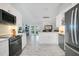 Open concept kitchen with island, stainless appliances, and access to outdoor space at 17927 E Apshawa Rd, Minneola, FL 34715