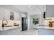 Bright kitchen features white cabinets, stainless appliances, and stylish countertops at 17927 E Apshawa Rd, Minneola, FL 34715