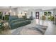 Open living space featuring a large couch, modern decor, lots of light, and sleek floors at 17927 E Apshawa Rd, Minneola, FL 34715