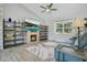 Relaxing living room with fireplace, large window, open shelves, and a comfortable couch at 17927 E Apshawa Rd, Minneola, FL 34715