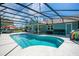 Inviting screened-in pool with a patio, lounge chairs, and manicured backyard at 17927 E Apshawa Rd, Minneola, FL 34715