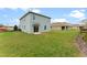 Spacious backyard features a well-maintained lawn and potential for outdoor activities at 1876 Three Bars Rd, Kissimmee, FL 34744