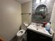 Updated half bath with new vanity, modern fixtures, round mirror, and accent tiling at 1909 Lakeview Pl, Kissimmee, FL 34759