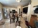 Eat-in kitchen featuring tile flooring, stainless steel appliances, and white cabinetry at 1909 Lakeview Pl, Kissimmee, FL 34759
