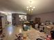 Spacious living room featuring tile flooring, chandelier lighting, and an open plan at 1909 Lakeview Pl, Kissimmee, FL 34759