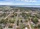 An aerial view of a quiet neighborhood with mature trees and well-maintained homes near a large lake at 203 E Lakeview Ave, Eustis, FL 32726