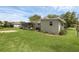 Spacious backyard featuring lush green grass and mature landscaping, providing a private outdoor retreat at 203 E Lakeview Ave, Eustis, FL 32726
