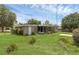 View of the backyard with a screened-in porch and lush greenery, creating a serene outdoor space at 203 E Lakeview Ave, Eustis, FL 32726