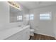 Bright bathroom featuring a vanity with a white countertop and white cabinets, along with wood-look flooring at 203 E Lakeview Ave, Eustis, FL 32726