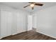 Bedroom features a ceiling fan, wood-look flooring, and closet at 203 E Lakeview Ave, Eustis, FL 32726