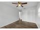 Bedroom featuring ceiling fan, wood-look flooring, and closet at 203 E Lakeview Ave, Eustis, FL 32726