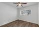 Cozy bedroom with ceiling fan, window with blinds, and wood-look flooring at 203 E Lakeview Ave, Eustis, FL 32726