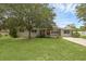 Charming single-story home featuring a brick exterior, mature landscaping, and a well-manicured lawn at 203 E Lakeview Ave, Eustis, FL 32726