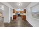 Modern kitchen with stainless steel appliances, wood cabinets, and wood-look flooring at 203 E Lakeview Ave, Eustis, FL 32726
