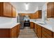 Bright kitchen with stainless steel appliances, wood cabinets, and updated countertops at 203 E Lakeview Ave, Eustis, FL 32726