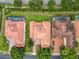 An aerial view shows a neighborhood with terra cotta roofs, mature trees, and well-manicured landscaping at 2209 Callaway Ct, Davenport, FL 33837