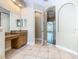Vanity with granite counters complements the tile floor and enhances the bathroom's design at 2209 Callaway Ct, Davenport, FL 33837