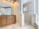 Bathroom features a tiled shower, vanity with cabinets, and decorative columns at 2209 Callaway Ct, Davenport, FL 33837