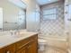 Bathroom featuring a bathtub, tiled shower, vanity, and toilet at 2209 Callaway Ct, Davenport, FL 33837