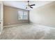 Cozy carpeted bedroom featuring a window and ample natural light at 2209 Callaway Ct, Davenport, FL 33837