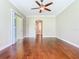 Spacious bedroom with wood floors, ceiling fan, and sliding doors leading to the outside at 2209 Callaway Ct, Davenport, FL 33837