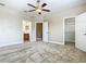 Spacious carpeted bedroom featuring a ceiling fan, walk-in closet, and en-suite bathroom at 2209 Callaway Ct, Davenport, FL 33837