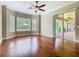 Bedroom with hardwood floor, ceiling fan, bay window, and sliding doors opening to the patio at 2209 Callaway Ct, Davenport, FL 33837