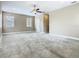 Large, carpeted bedroom features a ceiling fan and multiple windows for optimal comfort at 2209 Callaway Ct, Davenport, FL 33837