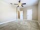Spacious carpeted bedroom featuring a ceiling fan, closet, and a door to the bathroom at 2209 Callaway Ct, Davenport, FL 33837