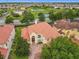 An eye-level view of a home with a tile roof and manicured lawn at 2209 Callaway Ct, Davenport, FL 33837