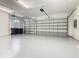 Spacious two-car garage with painted floor, storage, and automatic doors to keep your vehicles secure at 2209 Callaway Ct, Davenport, FL 33837