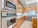 Modern kitchen featuring stainless steel appliances, granite countertops, and custom cabinetry at 2209 Callaway Ct, Davenport, FL 33837