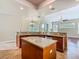 Bright kitchen featuring an island, granite countertops, stainless steel appliances, and tile flooring at 2209 Callaway Ct, Davenport, FL 33837