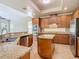 Well-appointed kitchen featuring granite countertops, stainless steel appliances, and a kitchen island at 2209 Callaway Ct, Davenport, FL 33837