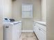 The laundry room features a sink, storage, and a window, creating a functional space at 2209 Callaway Ct, Davenport, FL 33837