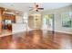 Open-concept floor plan showcasing the living room with hardwood floors and seamless transition to the kitchen at 2209 Callaway Ct, Davenport, FL 33837