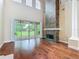 Spacious living room featuring a stone fireplace, hardwood floors, and sliding glass doors leading to the patio at 2209 Callaway Ct, Davenport, FL 33837