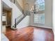 Interior view of a living room featuring hardwood floors, a staircase, and a large window at 2209 Callaway Ct, Davenport, FL 33837