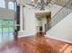 Interior showcasing hardwood floors, staircase with iron railing, and a view into the kitchen at 2209 Callaway Ct, Davenport, FL 33837