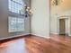 An interior view of a living room featuring hardwood floors, a large window, and high ceilings at 2209 Callaway Ct, Davenport, FL 33837
