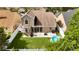 Aerial view of a fenced backyard with a pool, patio, and lush green lawn at 2235 Meadowmouse St, Orlando, FL 32837
